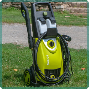 Portrait of a couple as a professional cleaners in uniform standing together with cleaning tools indoors